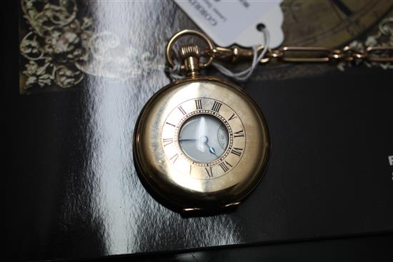 A George V 9ct gold Waltham half hunter pocket watch, on 15ct gold albert with 9ct gold gem set fob,